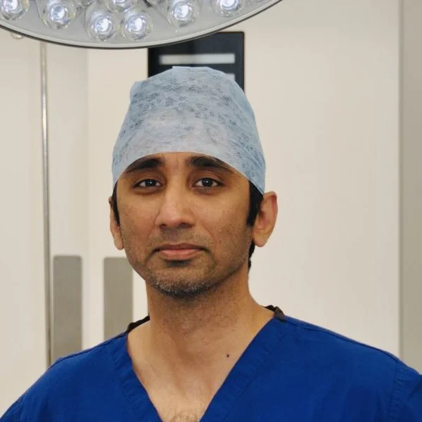 Mr Srikanth Reddy, consultant orthopaedic surgeon, in theatre scrubs and cap
